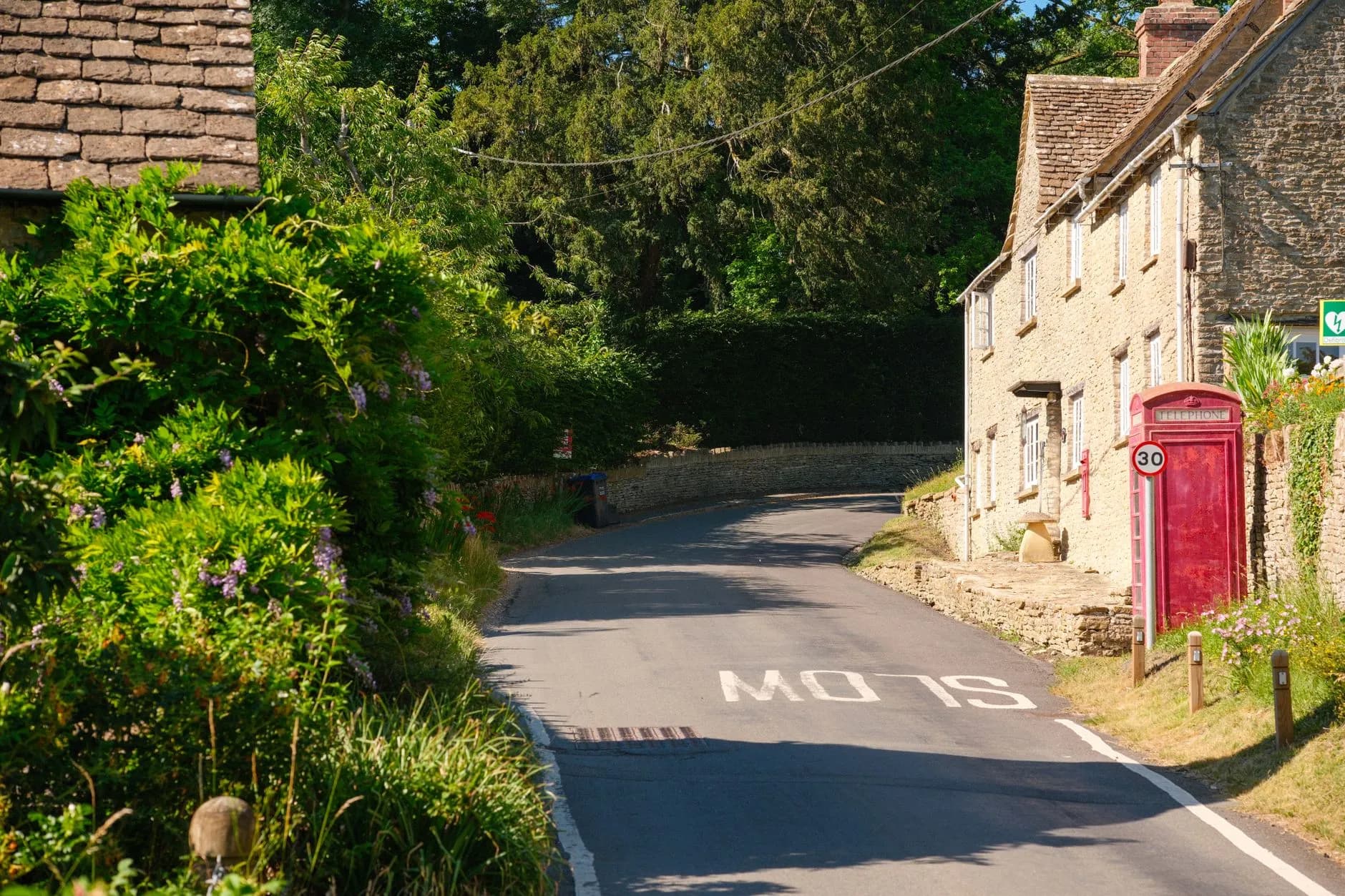 Village road with red phonebox.
