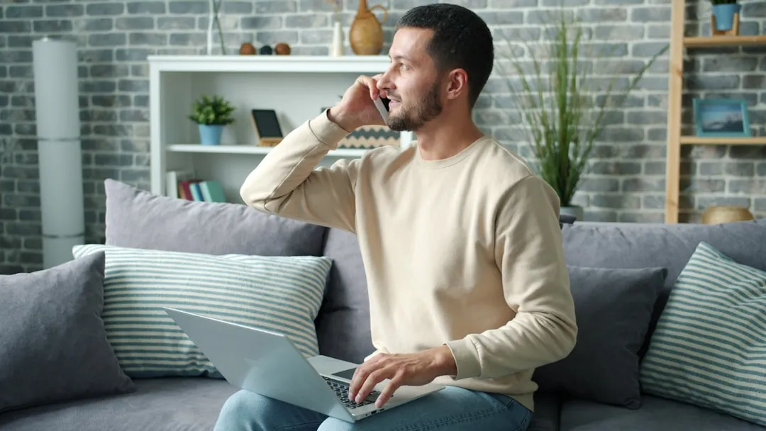 Man on phone with laptop