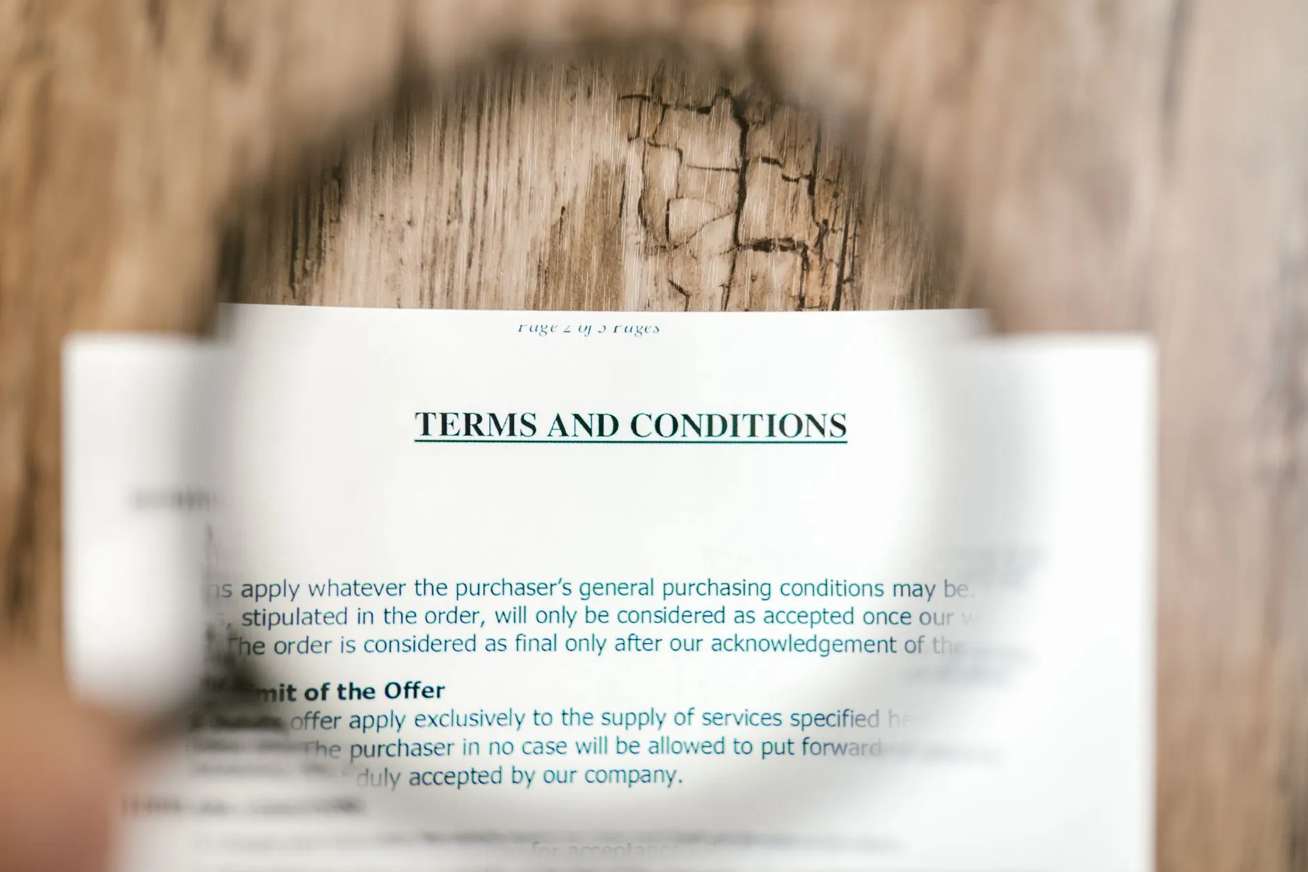 Magnifying glass over contract terms.