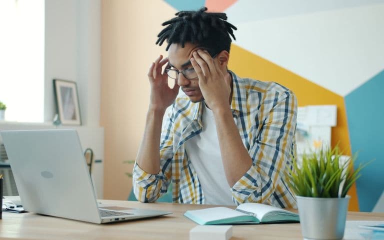 Frustrated man at laptop