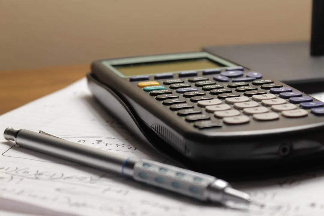 Calculator and pen on bills
