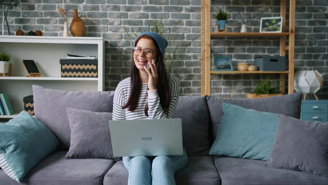Woman on phone with laptop